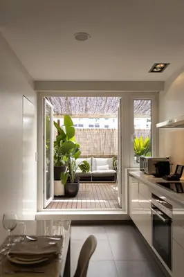 a kitchen with a view of a patio with a table at Porto Pátio by MP in Porto