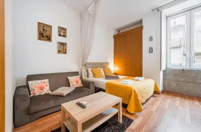 a living room with a couch and a table at Cimo Apartments - Center Porto in Porto