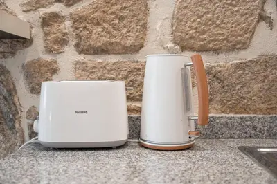 two toasters sitting on a counter next to a wall at Cimo Apartments - Center Porto in Porto
