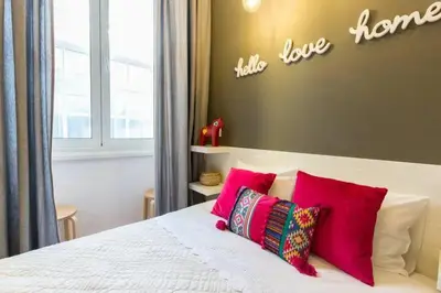 a bedroom with a bed with pink pillows at Downtown Porto Twins II - City Center in Porto