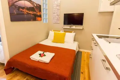 a small room with a bed with a counter top at Downtown Porto Twins II - City Center in Porto