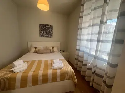 a small bedroom with a bed and a window at Apartment near Porto University Campus T2 in Porto