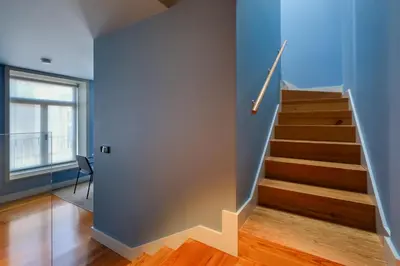 a staircase in a home with blue walls and wooden floors at Porto Heritage Balcony Apartment in Porto