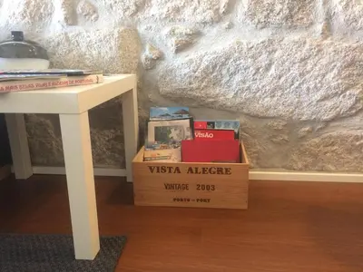 a box of books sitting next to a table at An apartment with a view - Nó's place in Vila Nova de Gaia
