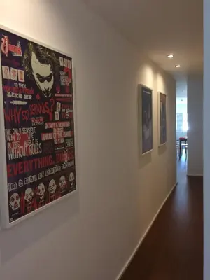 a hallway with two posters on a wall at An apartment with a view - Nó's place in Vila Nova de Gaia