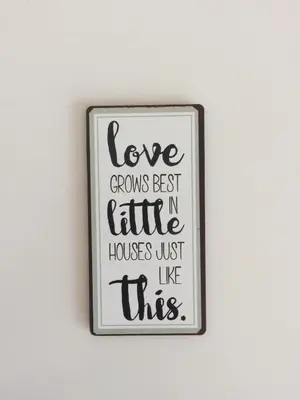 a sign that reads love grows best in little houses just like this at An apartment with a view - Nó's place in Vila Nova de Gaia