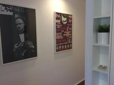 a wall with two posters on a wall at An apartment with a view - Nó's place in Vila Nova de Gaia