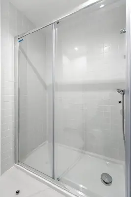 a shower with a glass door in a bathroom at An apartment with a view - Nó's place in Vila Nova de Gaia