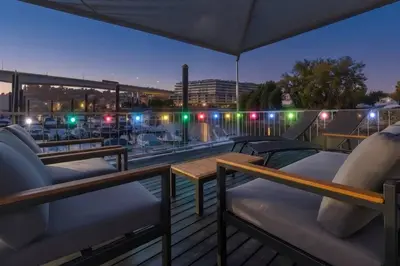 a deck with two beds on a boat at night at SLEEPBOAT- Modern Houseboat in Porto in Bicas
