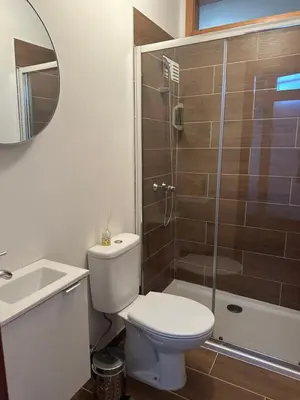 a bathroom with a toilet and a shower and a sink at Burnay Porto Suites in Porto