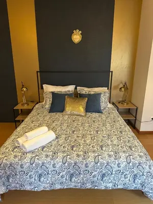 a bedroom with a bed with two towels on it at Burnay Porto Suites in Porto