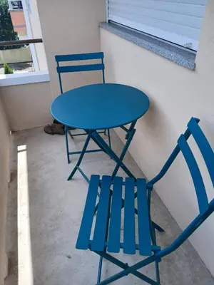 two blue chairs and a blue table and chairs at Charming Campanhã Family Home in Porto