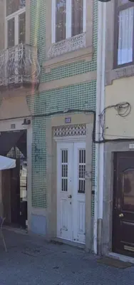 a building with a white door on a street at Pink Yellow Porto Apart in Porto