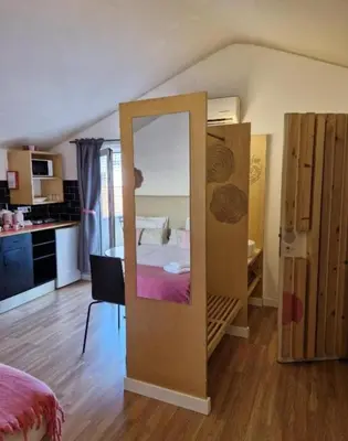 a room with a bed and a mirror in it at Pink Yellow Porto Apart in Porto