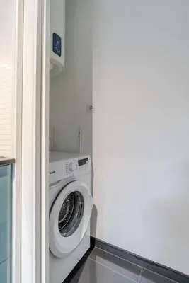 a washer and dryer in a laundry room at Duplex Studio in Art District by HostWise in Porto