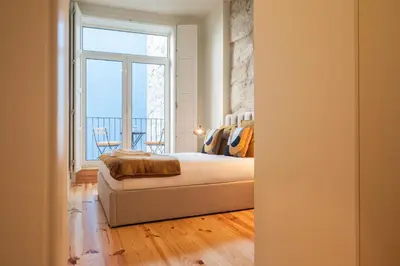 a bedroom with a bed and a large window at Luxury Style 20 with AC Downtown Porto near Metro in Porto