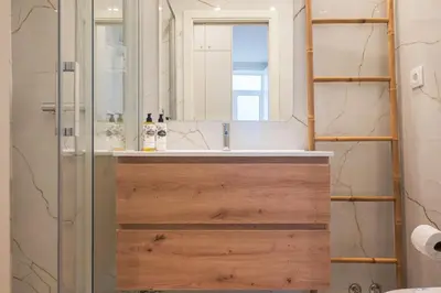 a bathroom with a sink and a mirror at Luxury Style 20 with AC Downtown Porto near Metro in Porto