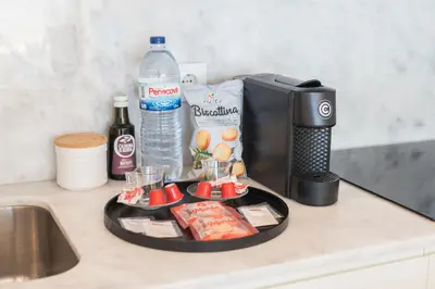 a kitchen counter with a tray of food and a water bottle at Luxury Style 30 with AC Downtown Porto near Metro in Porto