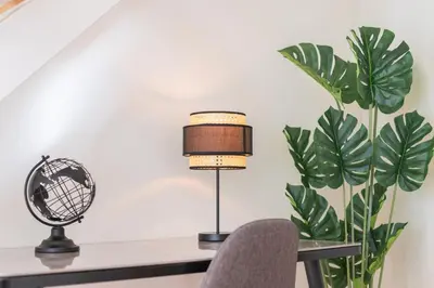 a desk with a lamp and a chair and a fan at Luxury Style 30 with AC Downtown Porto near Metro in Porto
