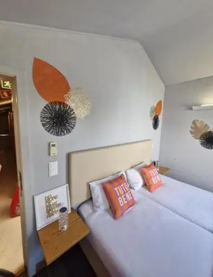 a bedroom with two twin beds and a table at Blue Orange Porto Apart in Porto