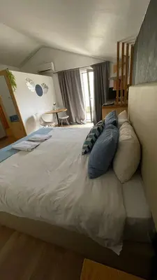 a bedroom with a large bed with pillows on it at Blue Orange Porto Apart in Porto