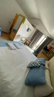 a large bed with blue pillows in a room at Blue Orange Porto Apart in Porto