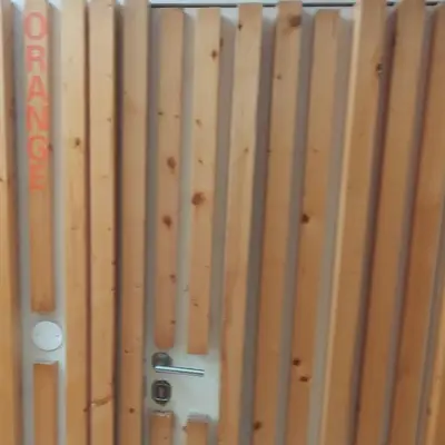 a close up of a wooden fence with a door at Blue Orange Porto Apart in Porto