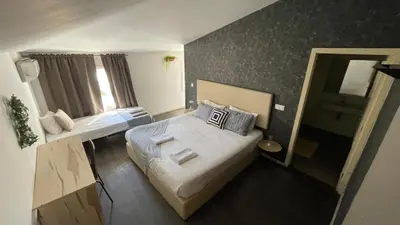 a small room with two beds and a window at Gray Red Porto Apart in Porto