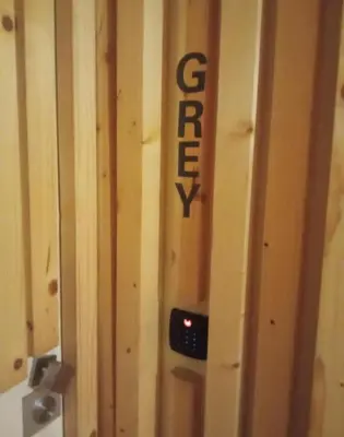a sign on the side of a wooden wall at Gray Red Porto Apart in Porto