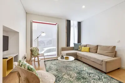 a living room with a couch and a table at D&S - Porto Theater Apartment in Porto