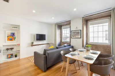 a living room with a table and a couch at D&S - Porto Theater Apartment in Porto