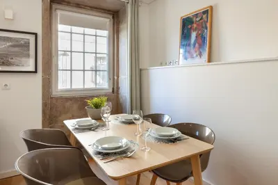 a dining room with a wooden table and chairs at D&S - Porto Theater Apartment in Porto
