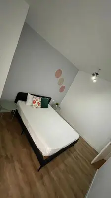 a bedroom with a bed in a corner with dots on the wall at Porto Bonfim suites in Porto