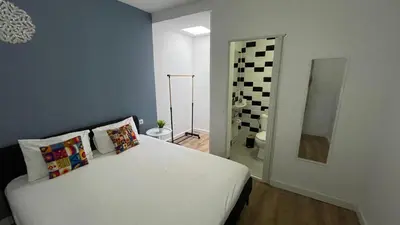 a bedroom with a white bed in a room at Porto Bonfim suites in Porto
