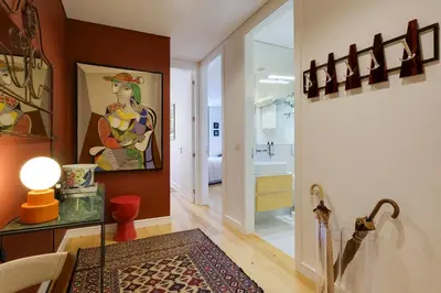 a living room with a painting of a woman on the wall at Quinta dos Cedros Garden & Terrace in Porto