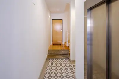 a hallway with a door and a tile floor at Quinta dos Cedros Garden & Terrace in Porto