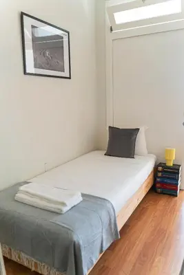 a small bedroom with a bed and a window at São João by Casa de Gondomil in Porto