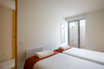 a room with a glass door and a chair at Casa Aurelia in Porto