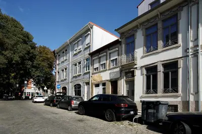a street with cars parked in front of buildings at Casa Aurelia in Porto