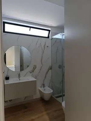 a bathroom with a sink and a mirror and a shower at Blue River - Douro Tower in Vila Nova de Gaia