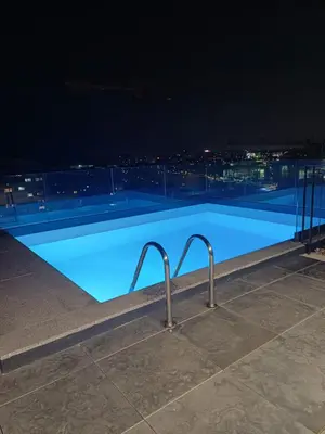 a swimming pool on the roof of a building at night at Blue River - Douro Tower in Vila Nova de Gaia