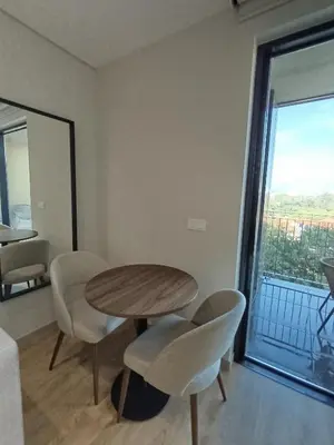 a table and chairs in a room with a window at Blue River - Douro Tower in Vila Nova de Gaia