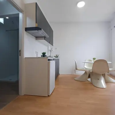 a kitchen with a refrigerator and a table and chairs at Your Home in Porto 1480 Style and Comfort in Porto