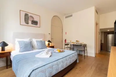 a bedroom with a bed with blue sheets and a table at Central & Cozy Studio by HostWise in Vila Nova de Gaia