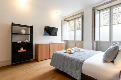 a hotel room with a bed and a tv at Central & Cozy Studio by HostWise in Vila Nova de Gaia