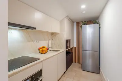 a kitchen with a refrigerator and a sink at Central & Cozy Studio by HostWise in Vila Nova de Gaia