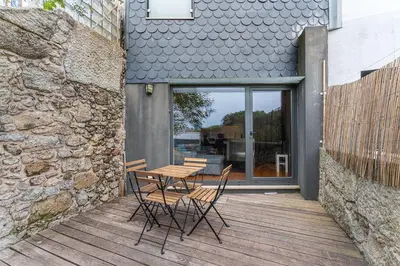 a wooden deck with a table and chairs on it at GuestReady - Peaceful retreat in Porto in Porto