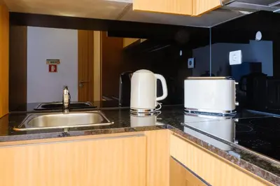 a kitchen with a sink and a counter top at Trindade Essence Duo Suites in Porto