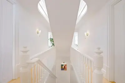 a white staircase with white railings in a home at City Retreat by Reframe stay in Porto in Porto