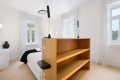 a bedroom with a bed and a book shelf at City Retreat by Reframe stay in Porto in Porto